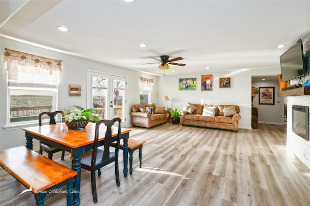 dining room with ceiling fan, light hardwood / wood-style floors, and french doors