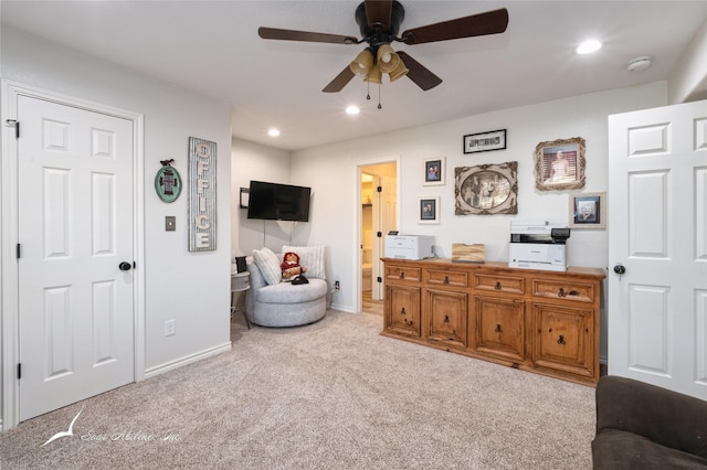 carpeted living room featuring ceiling fan