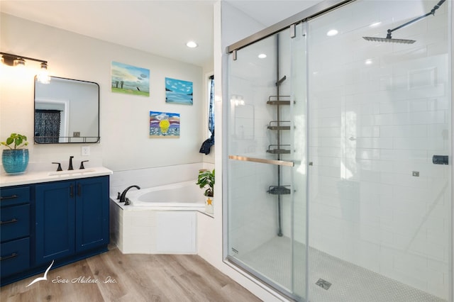 bathroom featuring independent shower and bath, vanity, and hardwood / wood-style floors