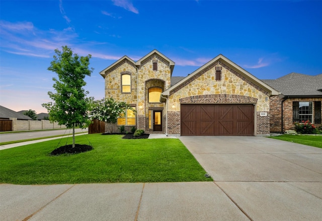 view of front facade with a garage and a yard