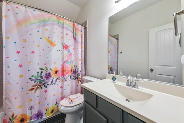 bathroom featuring vanity, walk in shower, and toilet