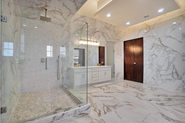 bathroom featuring vanity and an enclosed shower