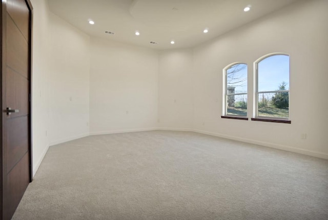 unfurnished room with light colored carpet