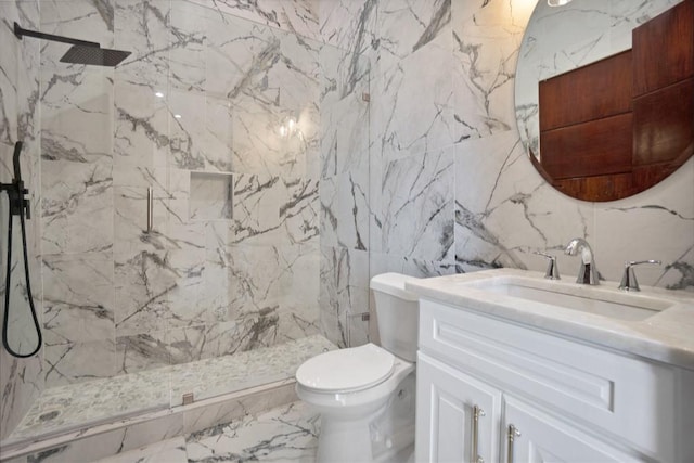 bathroom featuring vanity, toilet, and tiled shower