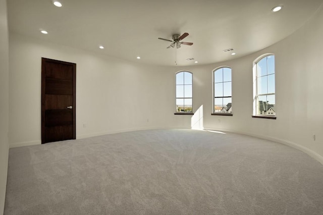 carpeted empty room featuring ceiling fan