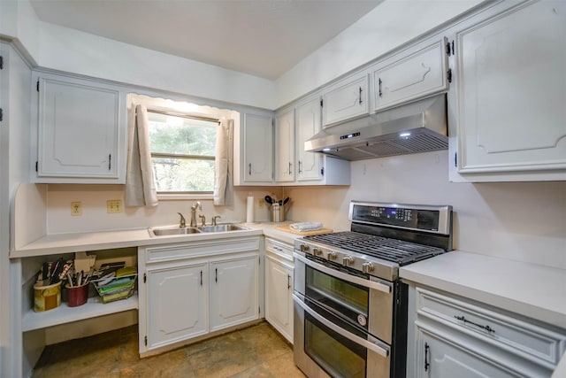 kitchen with white cabinetry, sink, and range with two ovens