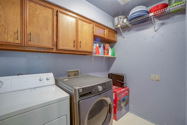 clothes washing area with cabinets and independent washer and dryer