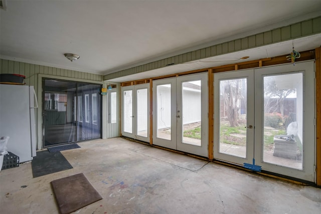 unfurnished sunroom featuring french doors and a healthy amount of sunlight