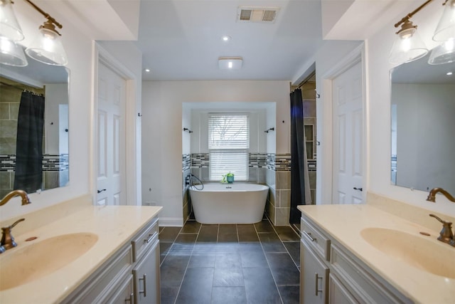 bathroom featuring tile patterned flooring, vanity, separate shower and tub, and tile walls