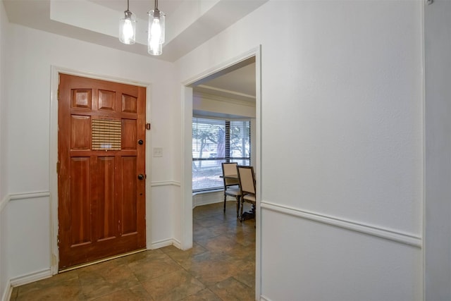 foyer with a tray ceiling