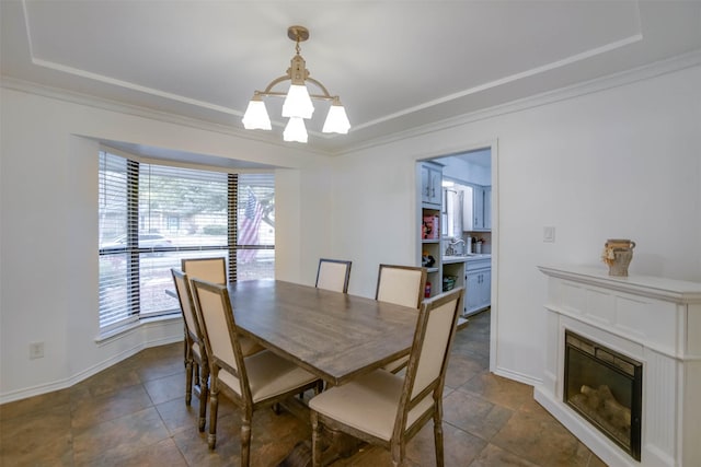 dining area featuring ornamental molding and a premium fireplace