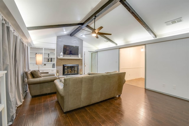 living room featuring a brick fireplace, dark wood-type flooring, lofted ceiling with beams, and ceiling fan