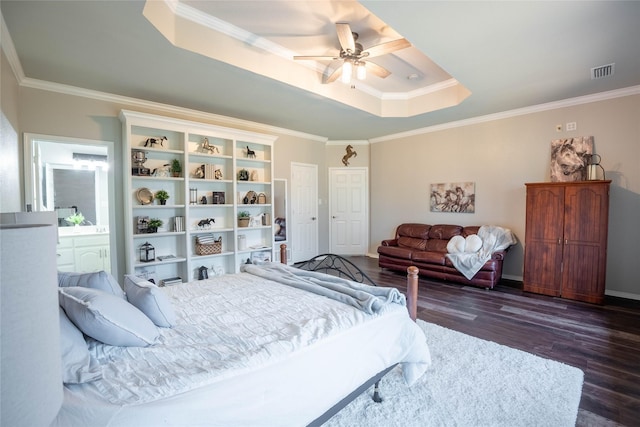 bedroom with ceiling fan, ornamental molding, dark hardwood / wood-style floors, and a raised ceiling