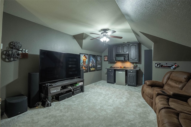 carpeted living room featuring ceiling fan, lofted ceiling, bar area, and a textured ceiling