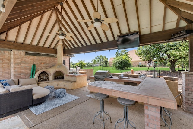 view of patio / terrace featuring a bar, a grill, area for grilling, ceiling fan, and a gazebo