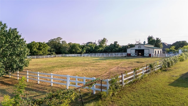 view of yard featuring a rural view and an outdoor structure