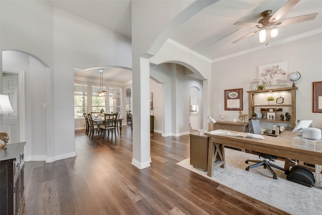 home office featuring dark wood-type flooring, ornamental molding, and ceiling fan