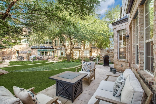 view of patio / terrace featuring a grill and an outdoor living space with a fire pit