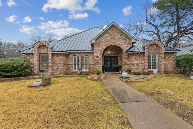 view of front of home with a front lawn and french doors