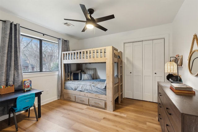 bedroom with ceiling fan, a closet, and light wood-type flooring