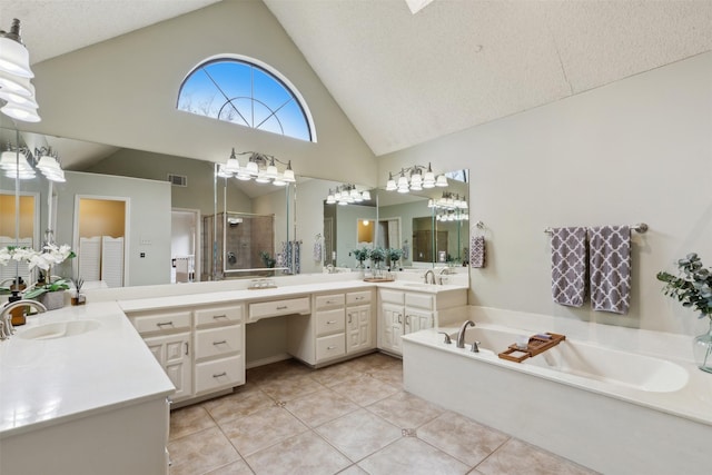 bathroom with tile patterned floors, high vaulted ceiling, a textured ceiling, vanity, and plus walk in shower