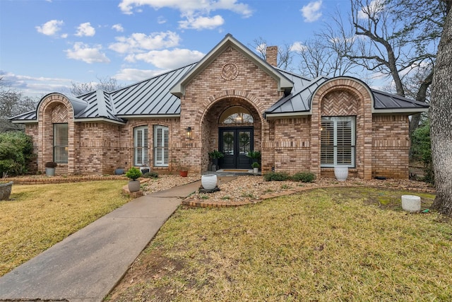 view of front of home featuring french doors and a front lawn