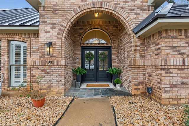 view of exterior entry featuring french doors