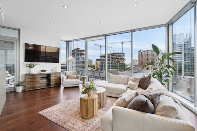 living room with dark wood-type flooring and floor to ceiling windows