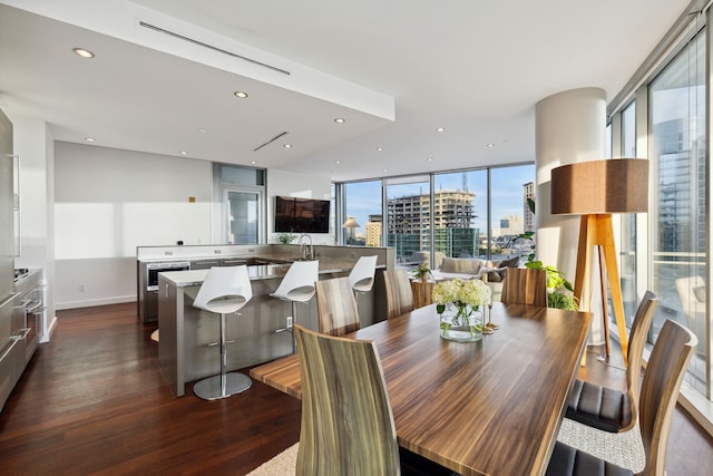 dining area with floor to ceiling windows and dark hardwood / wood-style floors