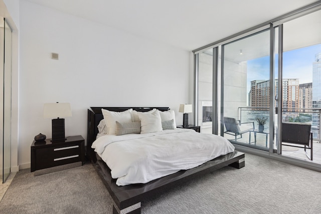 carpeted bedroom with floor to ceiling windows and access to exterior