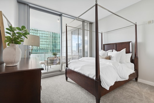 carpeted bedroom with floor to ceiling windows