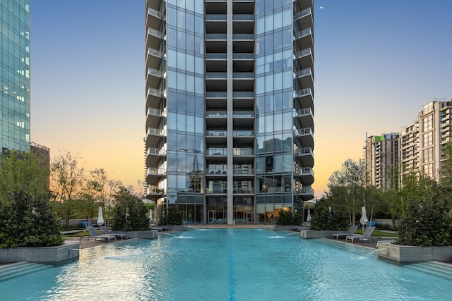 pool at dusk with pool water feature