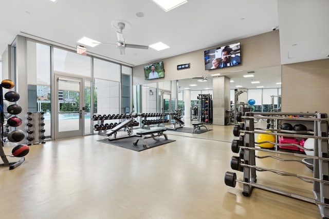 workout area with expansive windows and ceiling fan