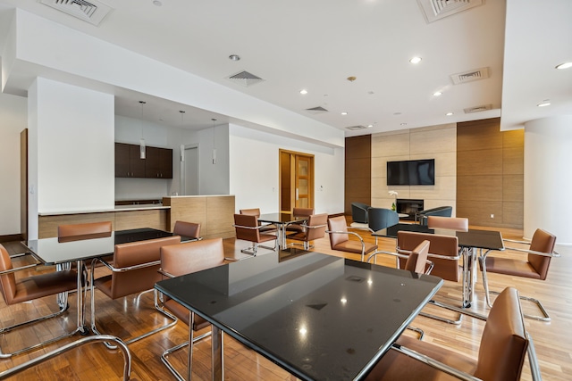 kitchen with a center island, a large fireplace, and light hardwood / wood-style flooring