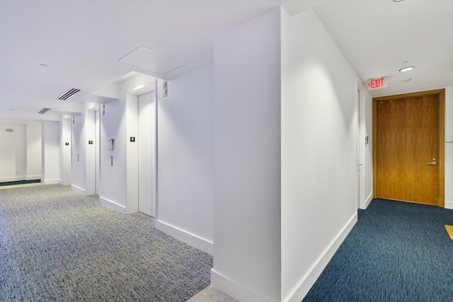 hallway with carpet floors