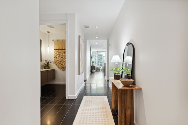 corridor with dark tile patterned floors