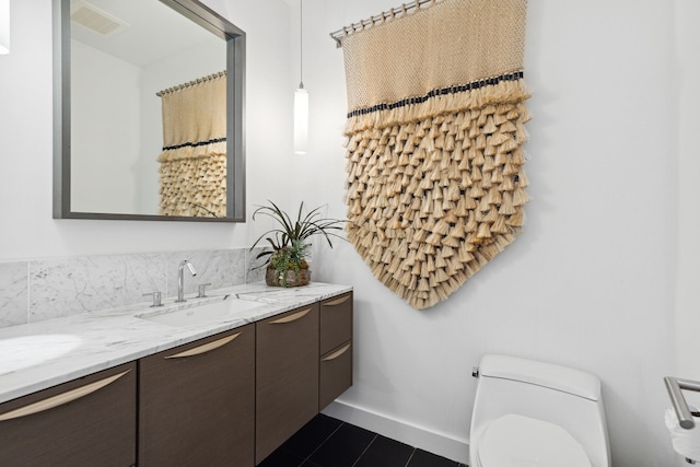 bathroom with vanity, tile patterned flooring, and toilet