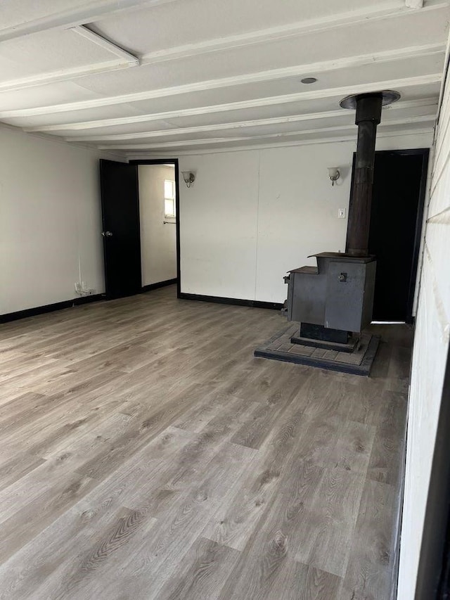 living room with hardwood / wood-style floors and a wood stove