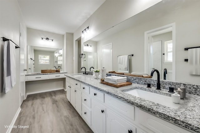 bathroom featuring a shower with door, vanity, and hardwood / wood-style floors