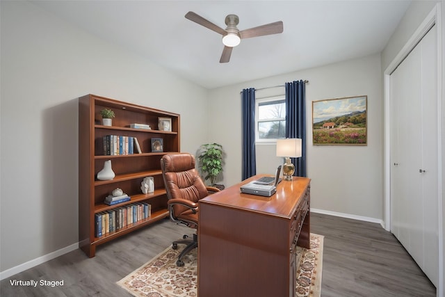 office featuring ceiling fan, baseboards, and wood finished floors