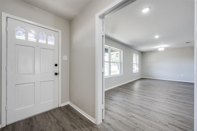 entrance foyer with dark wood finished floors, recessed lighting, and baseboards