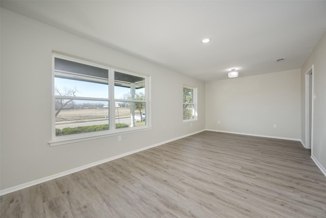 unfurnished room with wood-type flooring