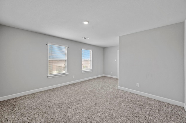 unfurnished room featuring carpet