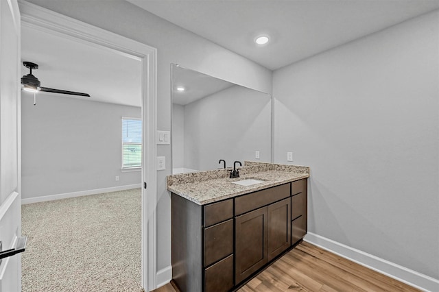 bathroom featuring vanity, wood-type flooring, and ceiling fan