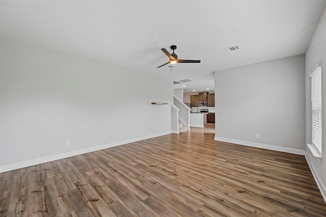 unfurnished living room featuring light hardwood / wood-style floors and ceiling fan