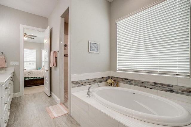 bathroom with vanity, shower with separate bathtub, and a wealth of natural light