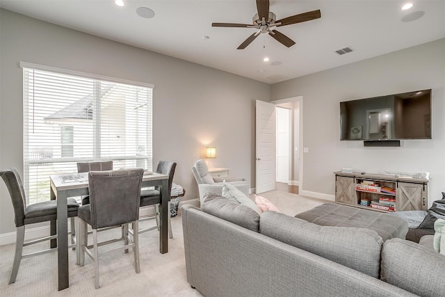 carpeted living room featuring ceiling fan