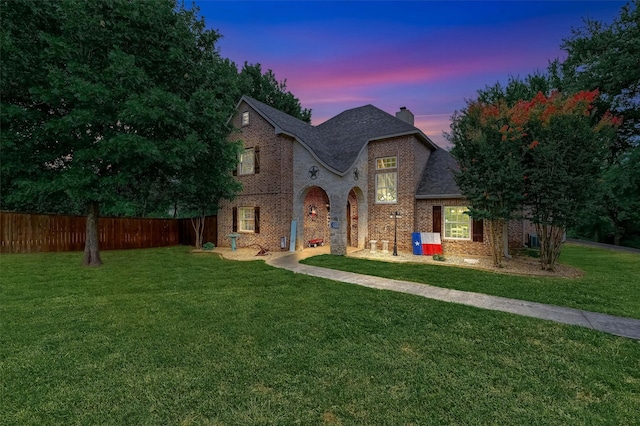 tudor-style house with a yard