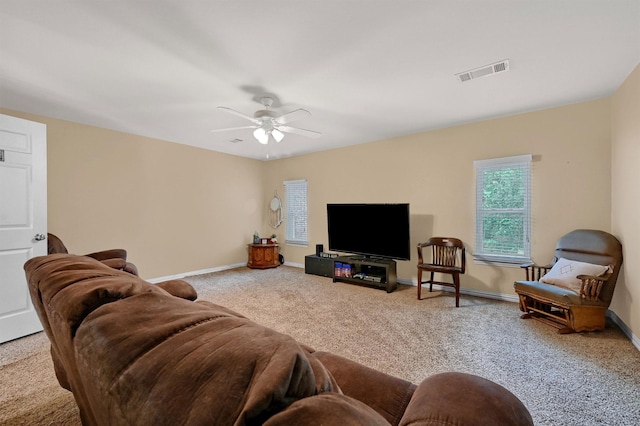 carpeted living room with ceiling fan