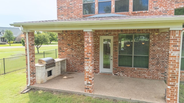 property entrance featuring a patio area and an outdoor kitchen